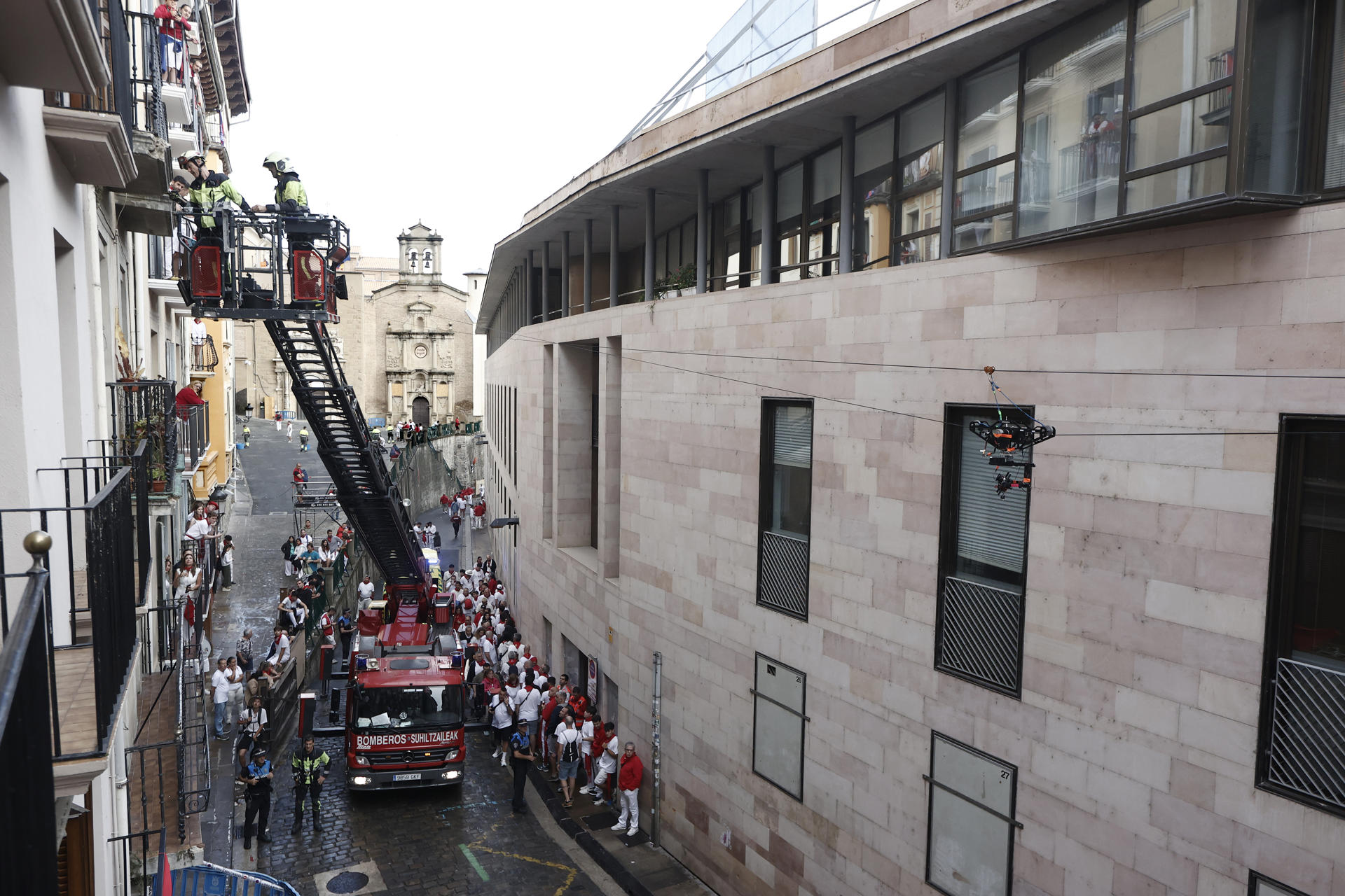 Un hombre de 58 años ha resultado herido en la cuesta de Santo Domingo poco antes del inicio del encierro a golpearle en el hombro un fragmento de cornisa desprendido de uno de los balcones que da al recorrido por el que cada mañana de los Sanfermines corren los toros. El desprendimiento de parte de la cornisa del balcón ha obligado a intervenir a los bomberos para limpiar y asegurar la fachada de la vivienda que se eleva sobre la Cuesta de Santo Domingo, un incidente que ha provocado un ligero retraso en el inicio del encierro de este sábado. EFE/ Jesús Diges