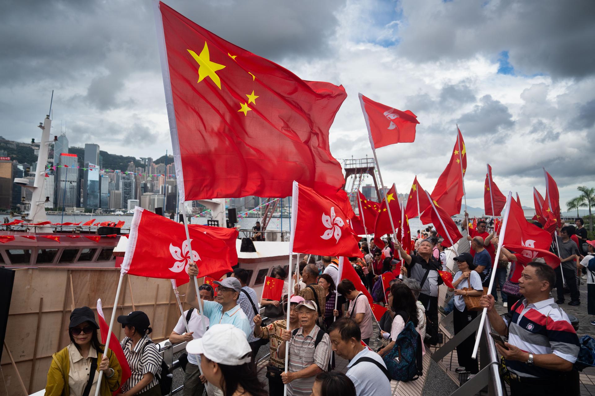 Asistentes agitan banderas de China y de la Región Administrativa Especial de Hong Kong (RAEHK) durante las celebraciones con motivo del 28º aniversario del retorno de la antigua colonia británica a la soberanía china, en Hong Kong, China, el 1 de julio de 2025. EFE/EPA/BERTHA WANG