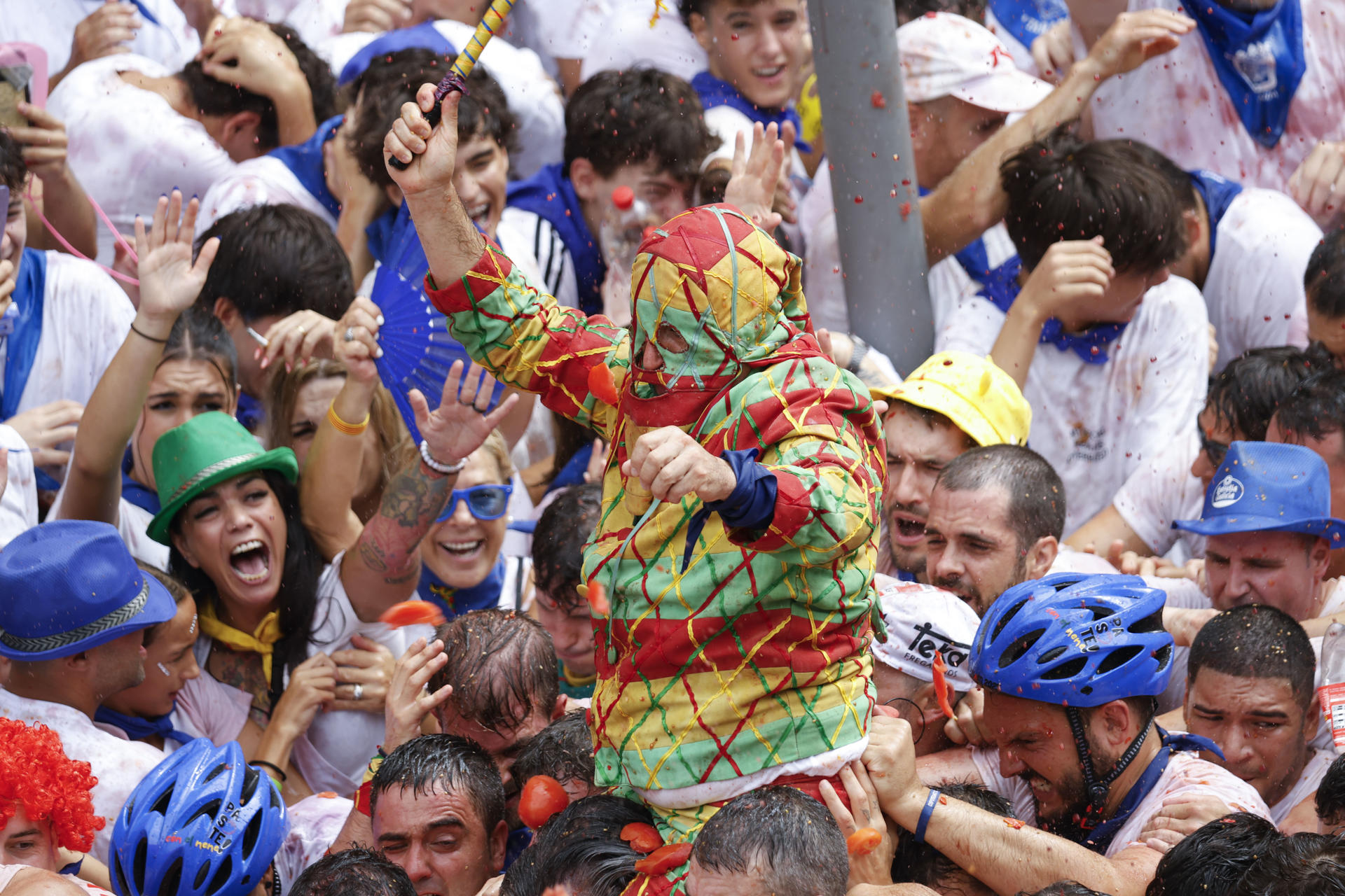 Miles de personas asisten este miércoles a la tradición del Cipotegato, que vuelve a pisar las calles de Tarazona (Zaragoza) bajo una lluvia de tomates,en un recorrido que comienza en el ayuntamiento de la ciudad y que ha elegido el joven o la joven que encarna este año al particular personaje, cuya identidad se mantiene oculta hasta que culmina la carrera, con la que se abren las fiestas en honor a San Atilano. EFE/JAVIER BELVER