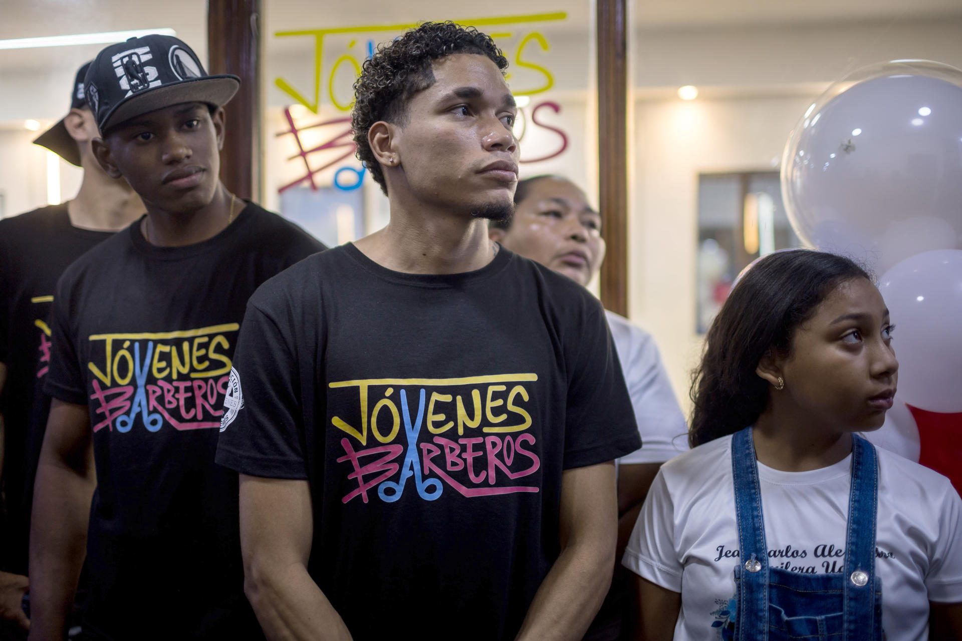 Fotografía del 28 de agosto de 2025 de un grupo de jóvenes posando antes de la inauguración de su barbería, en Caracas (Venezuela). EFE/ Miguel Gutiérrez