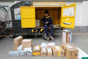 Imagen de archivo de un mensajero entre paquetes en Pekín (China) vendidos a través de internet por las plataformas del Grupo Alibaba. EFE/ Wu Hong