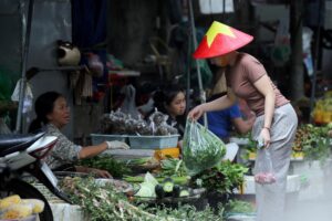 HANOI (Vietnam), 06/08/2025.- Una mujer compra vegetales en un mercado callejero de Vietnam. EFE/EPA/LUONG THAI LINH