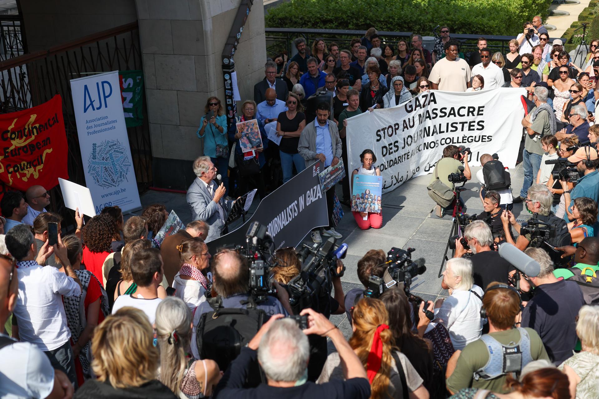 Los periodistas sostienen carteles mientras se reúnen para honrar la memoria de sus colegas asesinados en Gaza durante una protesta organizada por la Federación Internacional de Periodistas (FIP) en Bruselas, Bélgica, el 26 de agosto de 2025. Según la FIP, al menos 219 periodistas y trabajadores de medios palestinos han sido asesinados, varios han resultado heridos y otros están desaparecidos durante el conflicto en Gaza desde el 7 de octubre de 2023. (Protestas, Bélgica, Bruselas) EFE/EPA/Olivier Hoslet