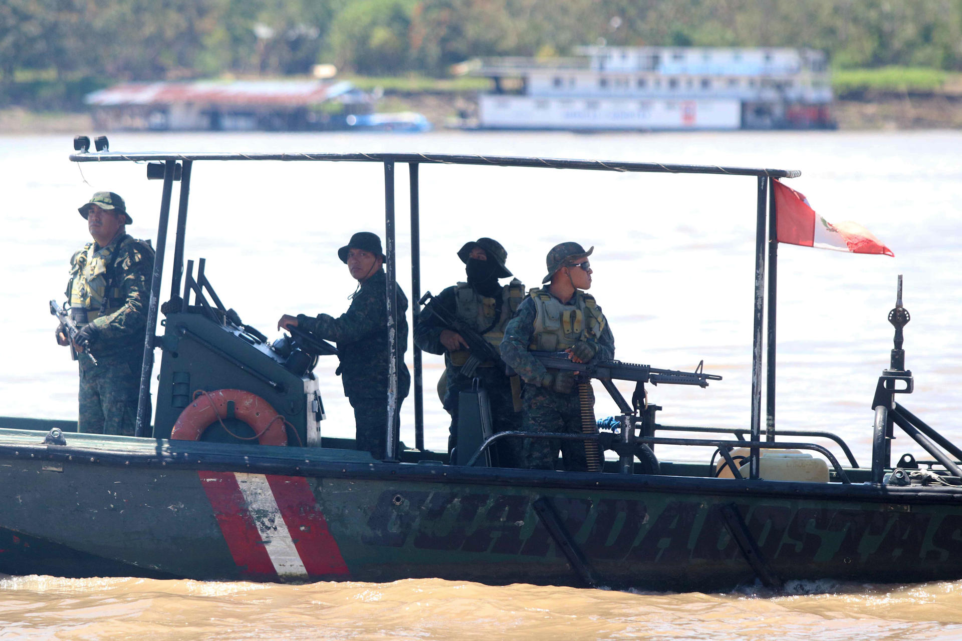 Integrantes del Ejército del Perú realizan patrullaje desde un bote guardacostas este miércoles, en la población de Santa Rosa, una isla en medio del río Amazonas bajo soberanía peruana, situada frente a la ciudad colombiana de Leticia, en la triple frontera amazónica con Brasil. EFE/ Stringer

