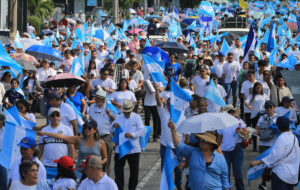 Personas sostienen banderas de Honduras durante una marcha por la paz este sábado, en San Pedro Sula (Honduras). EFE/ Jose Valle
