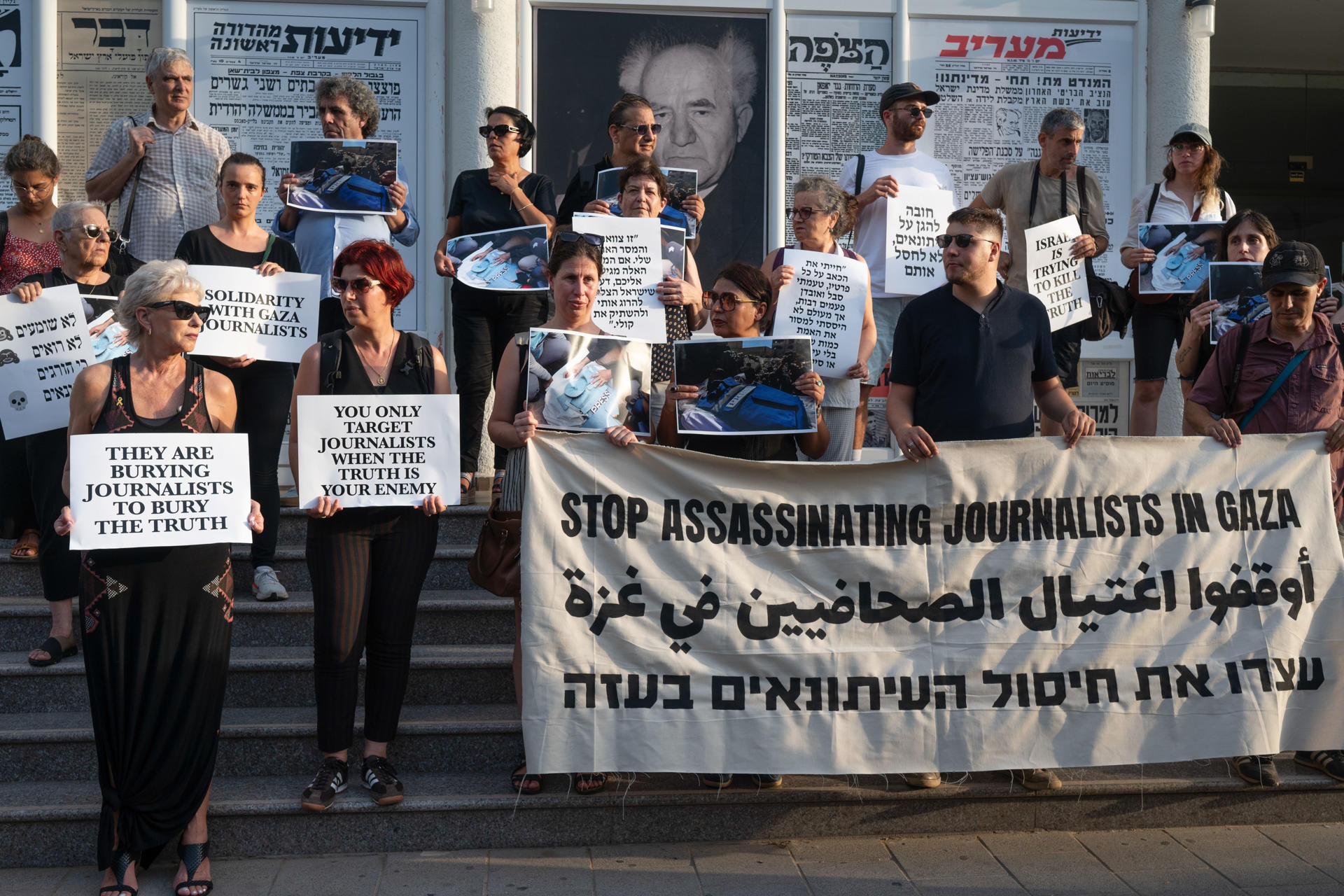 Una treintena de periodistas israelíes protestaron este miércoles en el centro de Tel Aviv por el asesinato, a manos del Ejército israelí, de decenas de reporteros palestinos en la Franja de Gaza. "Dejad de asesinar a periodistas en Gaza", podía leerse, en inglés, árabe y hebreo, en una de las pancartas exhibidas por el grupo, que se concentró en silencio durante una media hora en los escalones de entrada a la sede de la Asociación Nacional de Periodistas Israelíes. EFE/Magda Gibelli