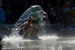 Varios niños se refrescan en un parque de la ciudad cántabra de Torrelavega.  EFE/Pedro Puente Hoyos