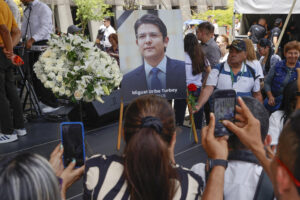 Personas toman fotografías a una imágen del fallecido senador y precandidato de Colombia Miguel Uribe Turbay, durante un homenaje este martes. EFE/ Mauricio Dueñas Castañeda