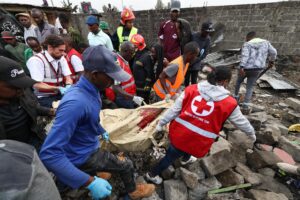 Socorristas recuperan un cuerpo entre los escombros del avión ambulancia Cessna Citation 560 que se estrelló en la zona de Mwihoko, en Githurai 45, Nairobi (Kenia). EFE/EPA/DANIEL IRUNGU