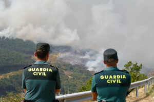 Dos agentes de la Guardia Civil observan la evolución del incendio de Ourense a punto de llegar a Castromil (Zamora). EFE/Mariam A. Montesinos