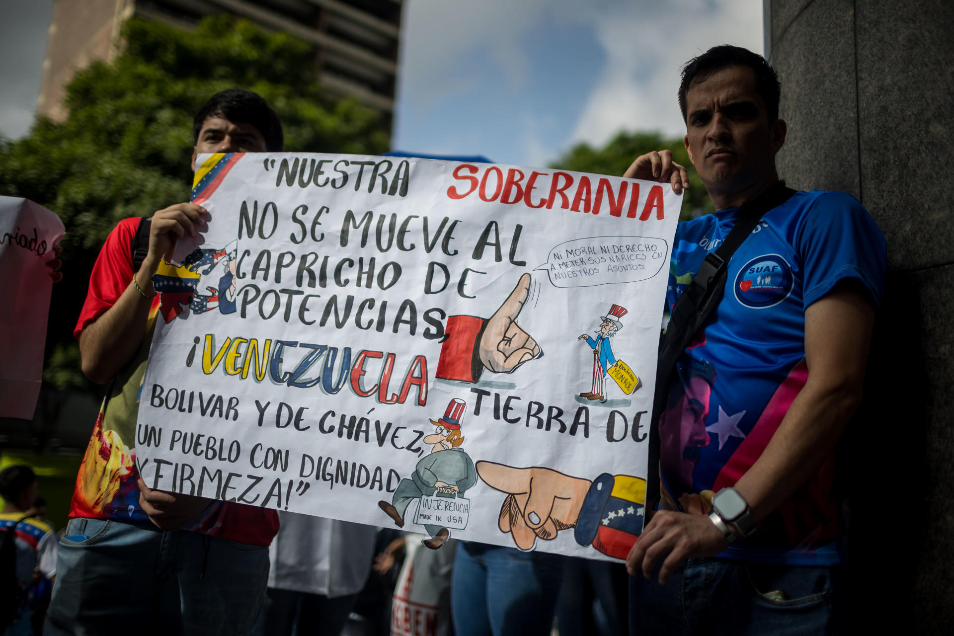 Personas sostienen un cartel en una manifestación de apoyo al presidente de Venezuela, Nicolás Maduro, este martes, en Caracas (Venezuela). EFE/ Miguel Gutierrez
