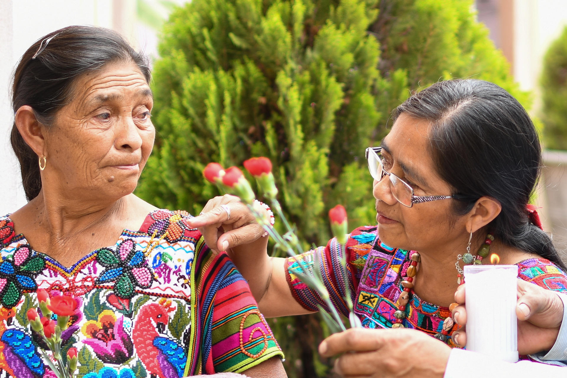 Un par de mujeres fue captado este jueves, 28 de agosto, durante un homenaje a las víctimas de desaparición en Guatemala, durante un acto que honra su memoria, en Ciudad de Guatemala. EFE/Alex Cruz