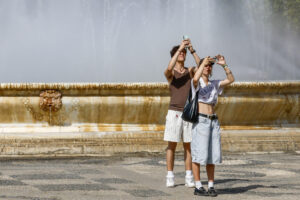 Dos turistas toman fotografías este lunes en el parque de María Luisa de Sevilla. EFE /Jose Manuel Vidal