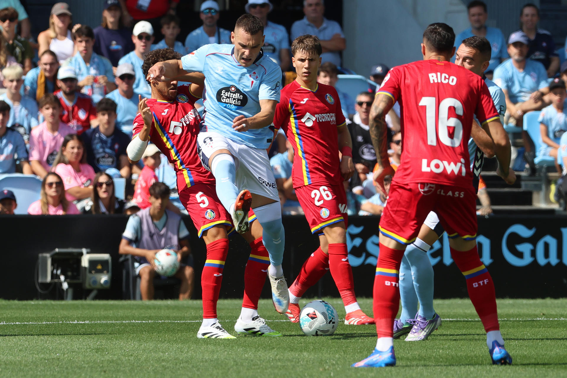 El delantero del Celta de Vigo Ferran Jutglà (2i) lucha por el balón con el centrocampista del Getafe Luis Milla (i) durante el partido de LaLiga disputado este domingo en el estadio de Balaídos en Vigo. EFE/ Salvador Sas