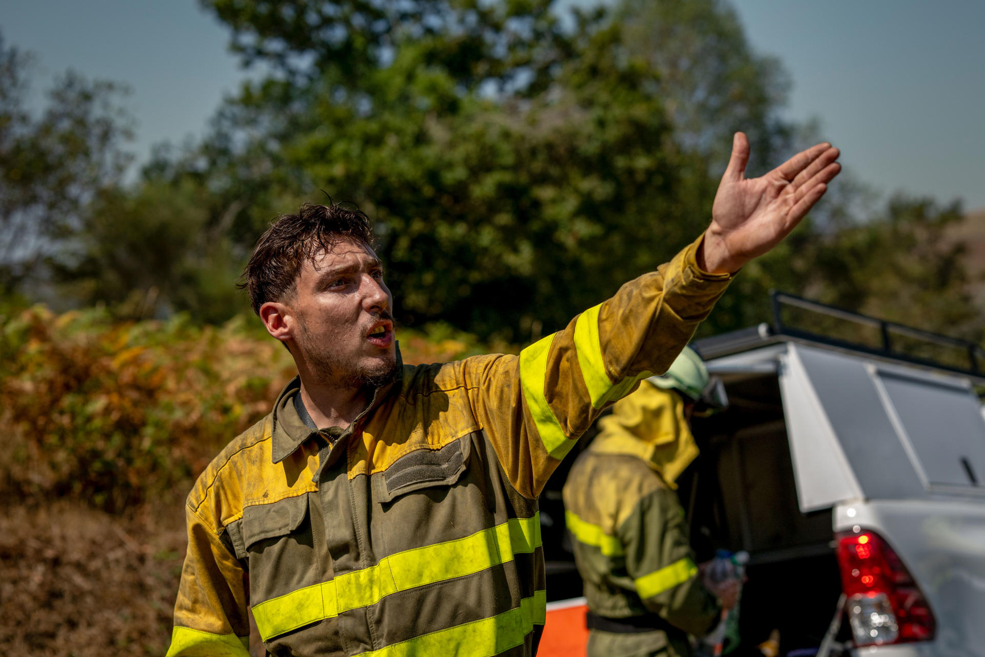 Un bombero da instrucciones durante el incendio forestal declarado ayer en Avión (Ourense), este lunes. EFE/Brais Lorenzo