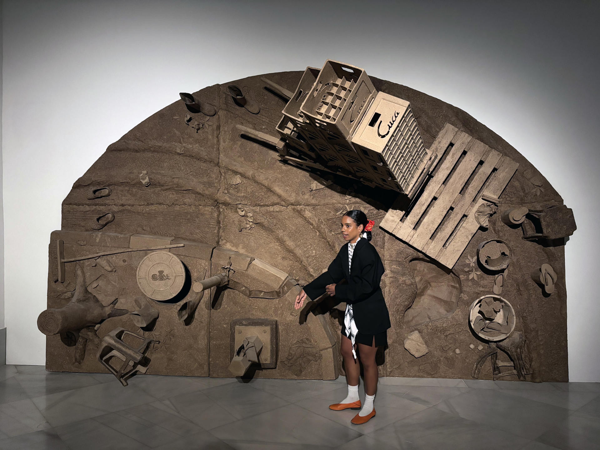 La artista angoleña Sandra Poulson (Luanda, Angola, 1995) junto a una de sus tres instalaciones efectuadas con reproducciones en gran tamaño y coloreadas de objetos de la vida cotidiana y de fragmentos arquitectónicos, agrupadas bajo el título "Donde el polvo respira", es la propuesta sobre la memoria colectiva de su país, en el Centro Andaluz de Arte Contemporáneo (CAAC) en la Cartuja de Sevilla. EFE/Laura Rincón