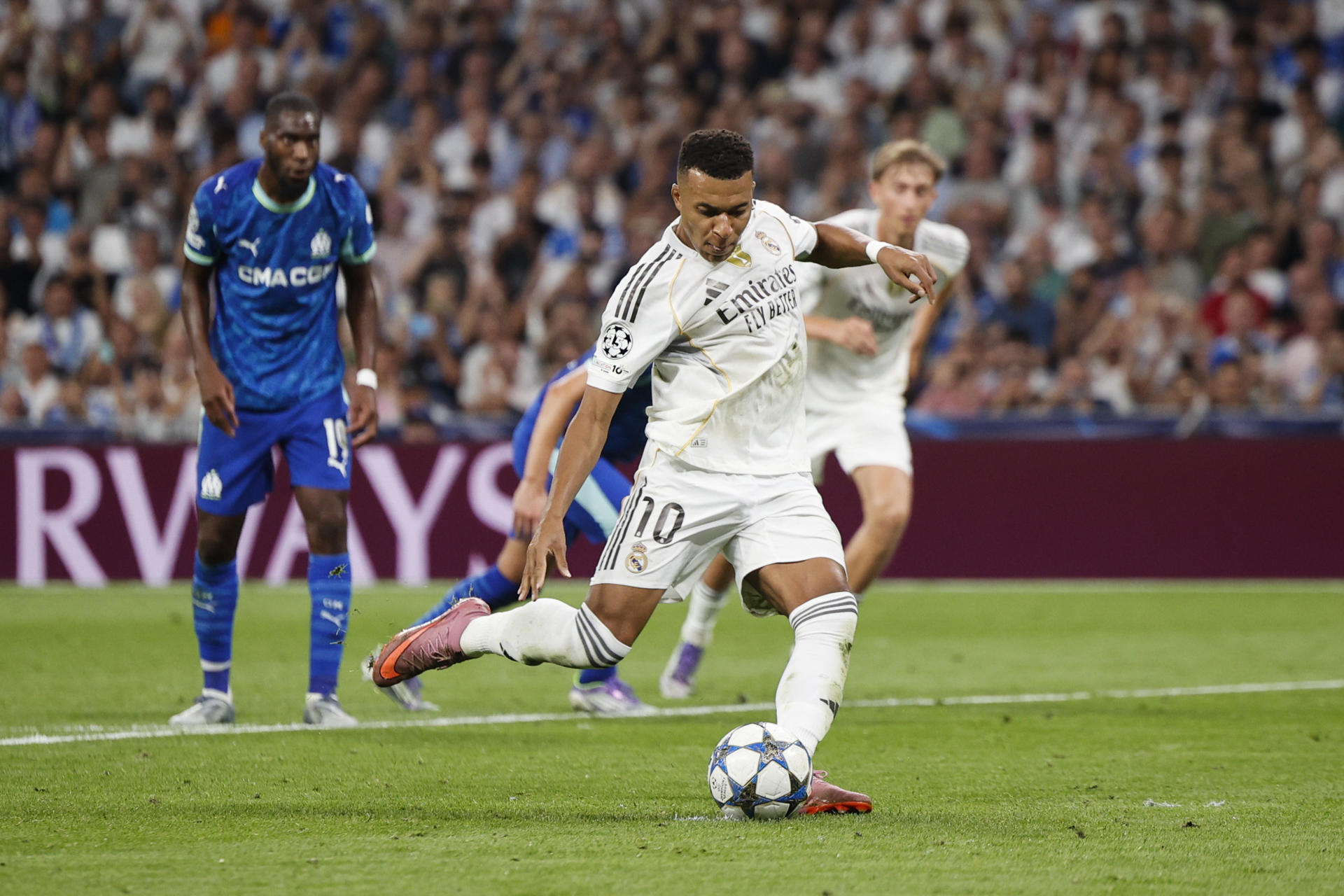El delantero del Real Madrid Kylian Mbappé lanza un penalti para marcar ante el Olympique, durante el partido de la primera jornada de la Liga de Campeones que Real Madrid y Olympique de Marsella disputan este martes en el estadio Santiago Bernabéu. EFE/Daniel González