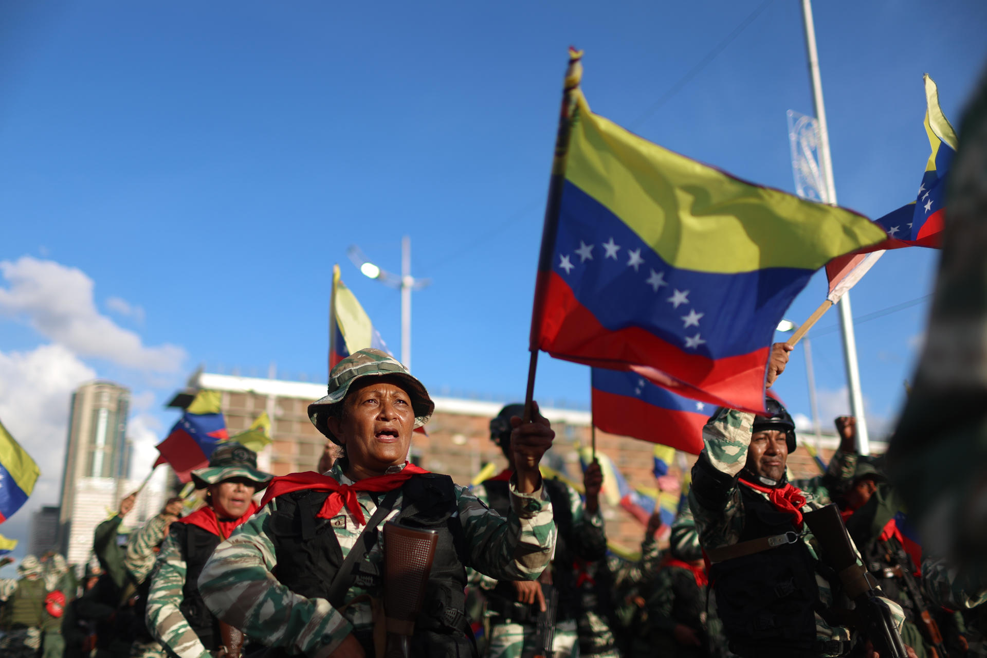 Personas sostienen banderas durante un ejercicio militar este martes en Caracas (Venezuela).EFE/ Miguel Gutiérrez
