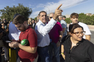 El portavoz nacional de Vox de inmigración, interior y seguridad Samuel Vázquez (i) increpa al secretario de comunicación de Podemos en Murcia Víctor Egío, tras la rueda de prensa que ha ofrecido este miércoles junto al centro de menas de Santa Cruz, que estaba acordonado por agentes de la guardia civil. EFE/Marcial Guillén
