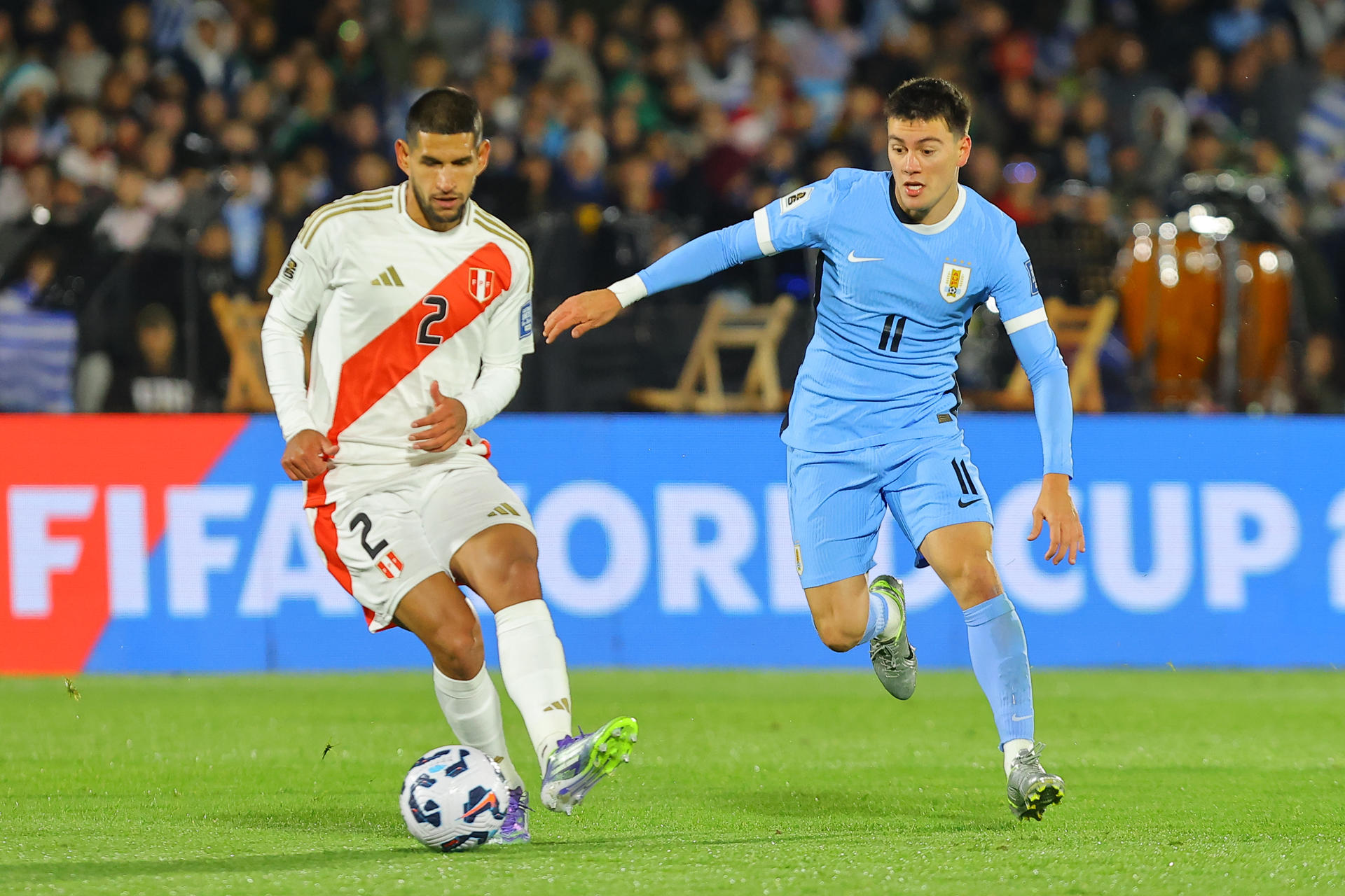 Facundo Pellistri (d) de Uruguay disputa el balón con Luis Abram de Perú en un partido por las eliminatorias a la Copa Mundial 2026 entre Uruguay y Perú en el estadio Centenario en Montevideo (Uruguay) EFE/ Gastón Britos