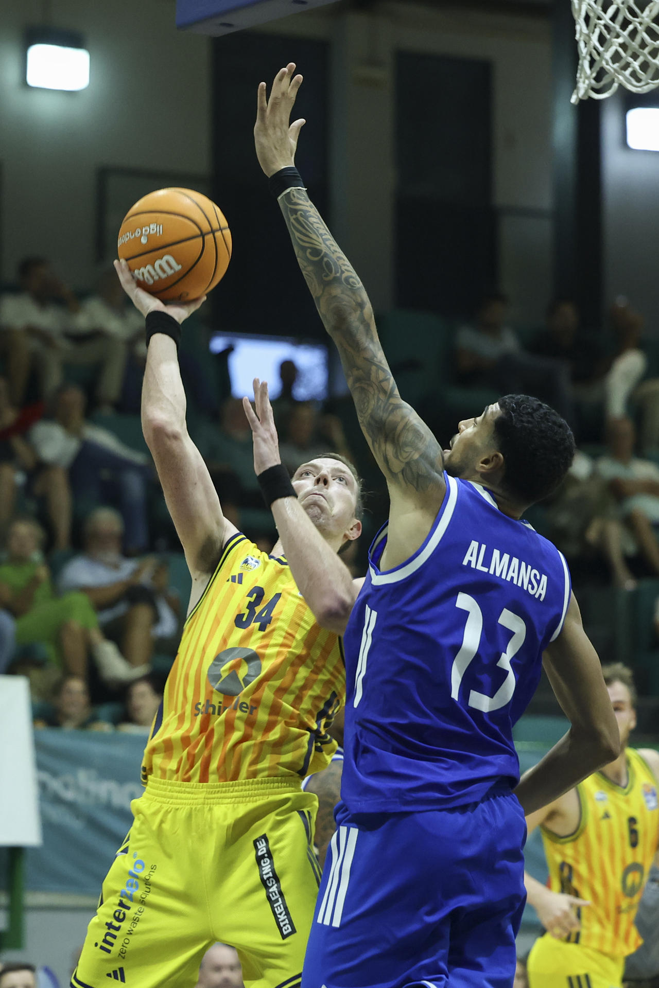 El ala-pívot del Alba Berlín Justin Bean (i) entra a canasta ante el ala-pívot del Real Madrid Izan Almansa (d) durante el encuentro entre Real Madrid y Alba Berlín del XIV Torneo Costa del Sol que se disputa en el pabellón San Miguel de la localidad de Torremolinos. EFE/Daniel Pérez