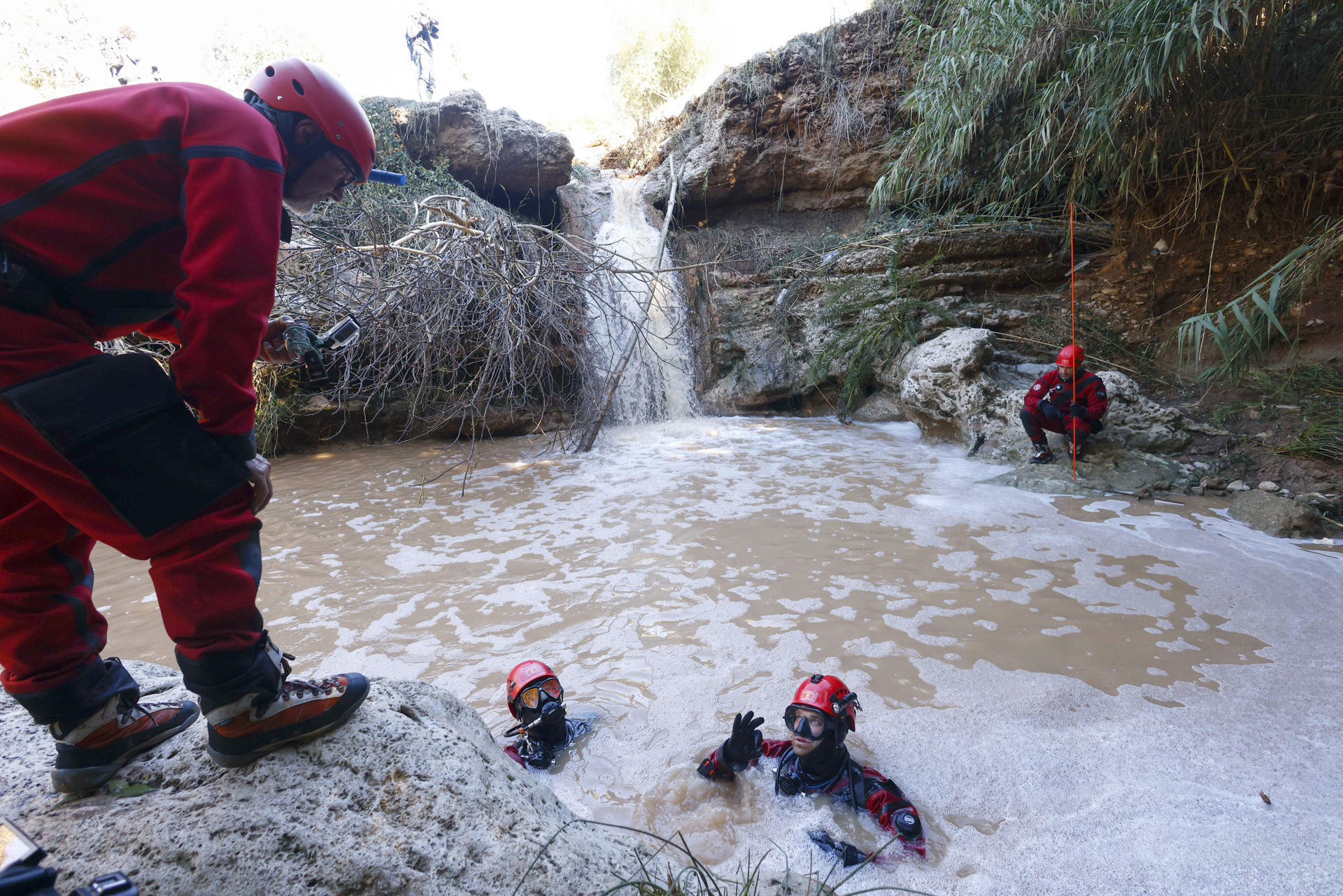 Unos noventa efectivos de los Bomberos de la Generalitat este lunes en las tareas de búsqueda del hombre desaparecido ayer domingo cuando la riera de Sant Quintí de Mediona (Barcelona) arrastró el coche en el que viajaba junto a su hijo, cuyo cadáver fue encontrado anoche. EFE/Quique García