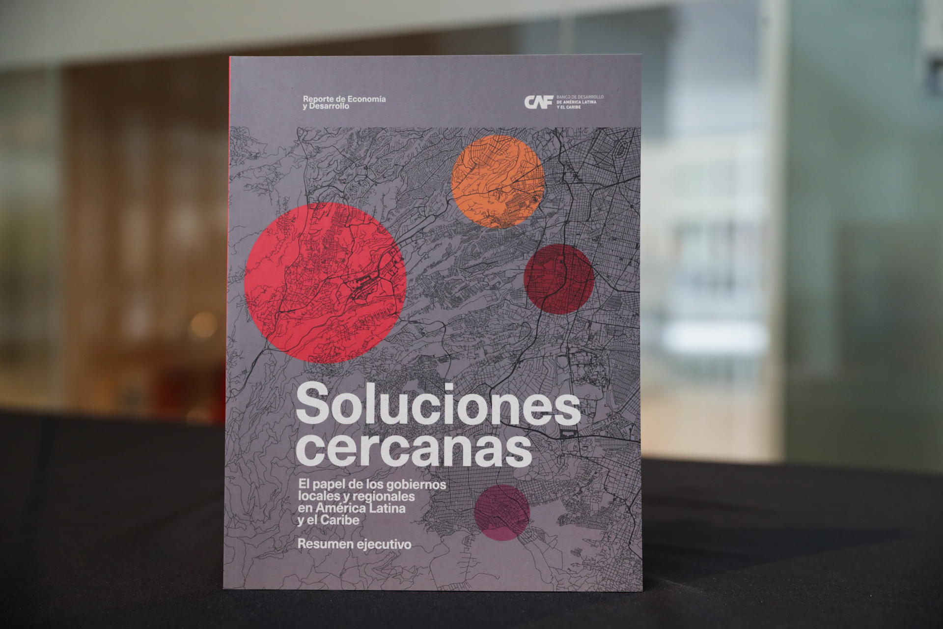 Fotografía de un ejemplar del resumen ejecutivo del reporte 'Soluciones cercanas: el papel de los gobiernos locales y regionales en América Latina y el Caribe' este lunes, en la sede del CAF en Montevideo (Uruguay). EFE/ Alejandro Prieto