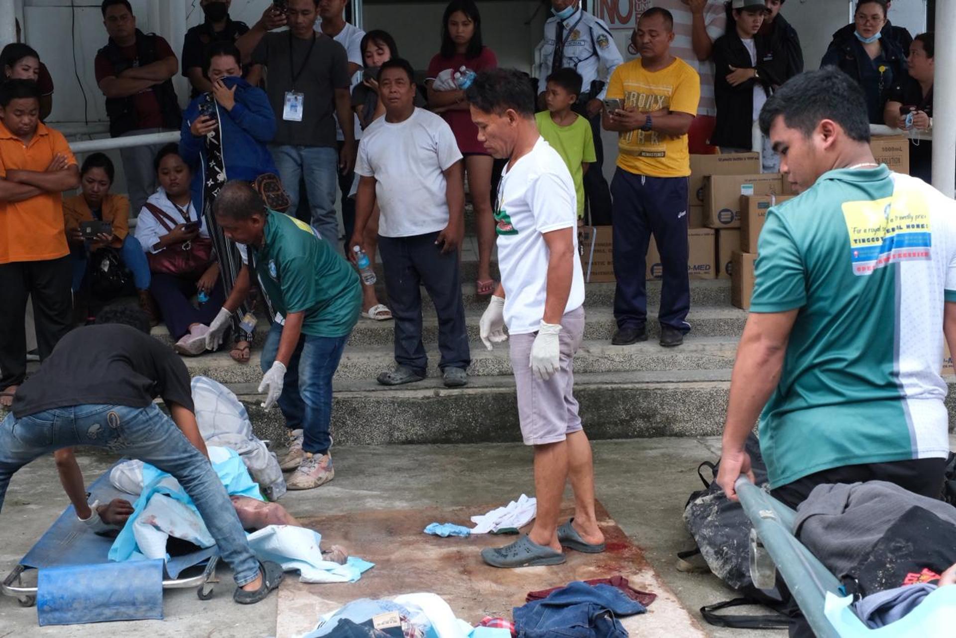Un grupo de filipinas con una víctima del terremoto que azotó el archipiélago. 
EFE/EPA/JUANITO ESPINOSA EDITORS NOTE: GRAPHIC CONTENT