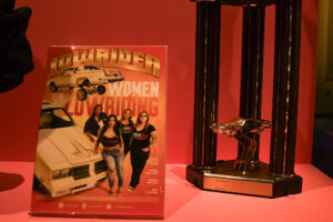 Detalle de un cuadro con una fotografía de un club de autos lowrider de mujeres de California junto a un trofeo al mejor Lowrider durante la exposición 'Corazón y Vida' este jueves, en Washington (Estados Unidos). EFE/David Toro