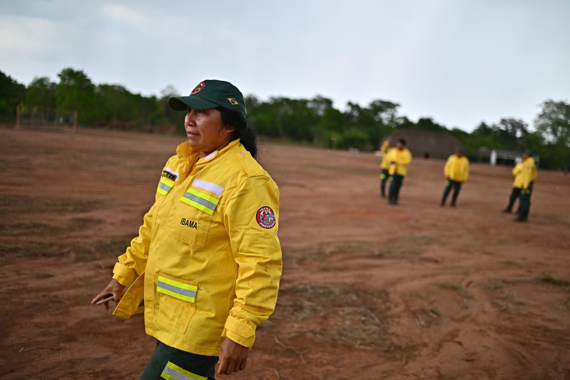 Fotografía del 26 de septiembre de 2025 que muestra a la indígena Lanalu kuikuro, una de las pocas mujeres indígenas que trabajan como brigadistas voluntarias en la región de Xingu, caminando luego de una conversación de indígenas de las etnias Kuikuro y Kaluan con brigadistas del Centro Nacional de Prevención y Combate de Incendios Forestales (Prevfogo) en la aldea Kaluani-Paraiso, en el Parque Indígena do Xingu cerca de Gaúcha do Norte (Brasil). EFE/Andre Borges
